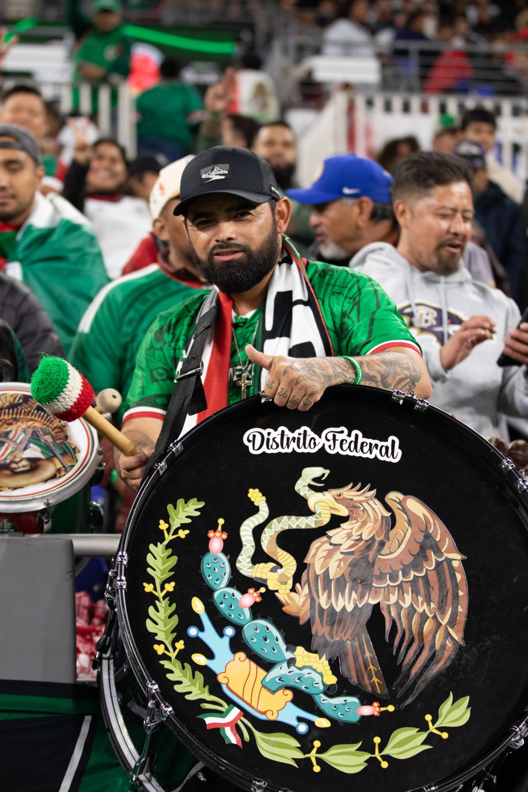 A Mexico supporter with a decorated Distrito Federal drum.