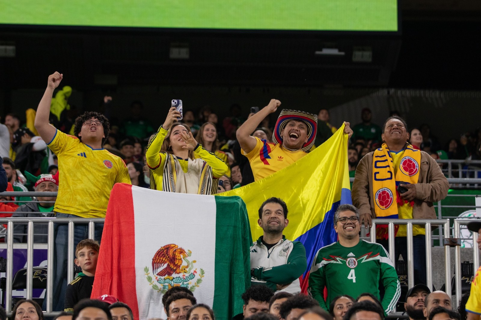Colombia and Mexico supporters bring their colors to the stands.