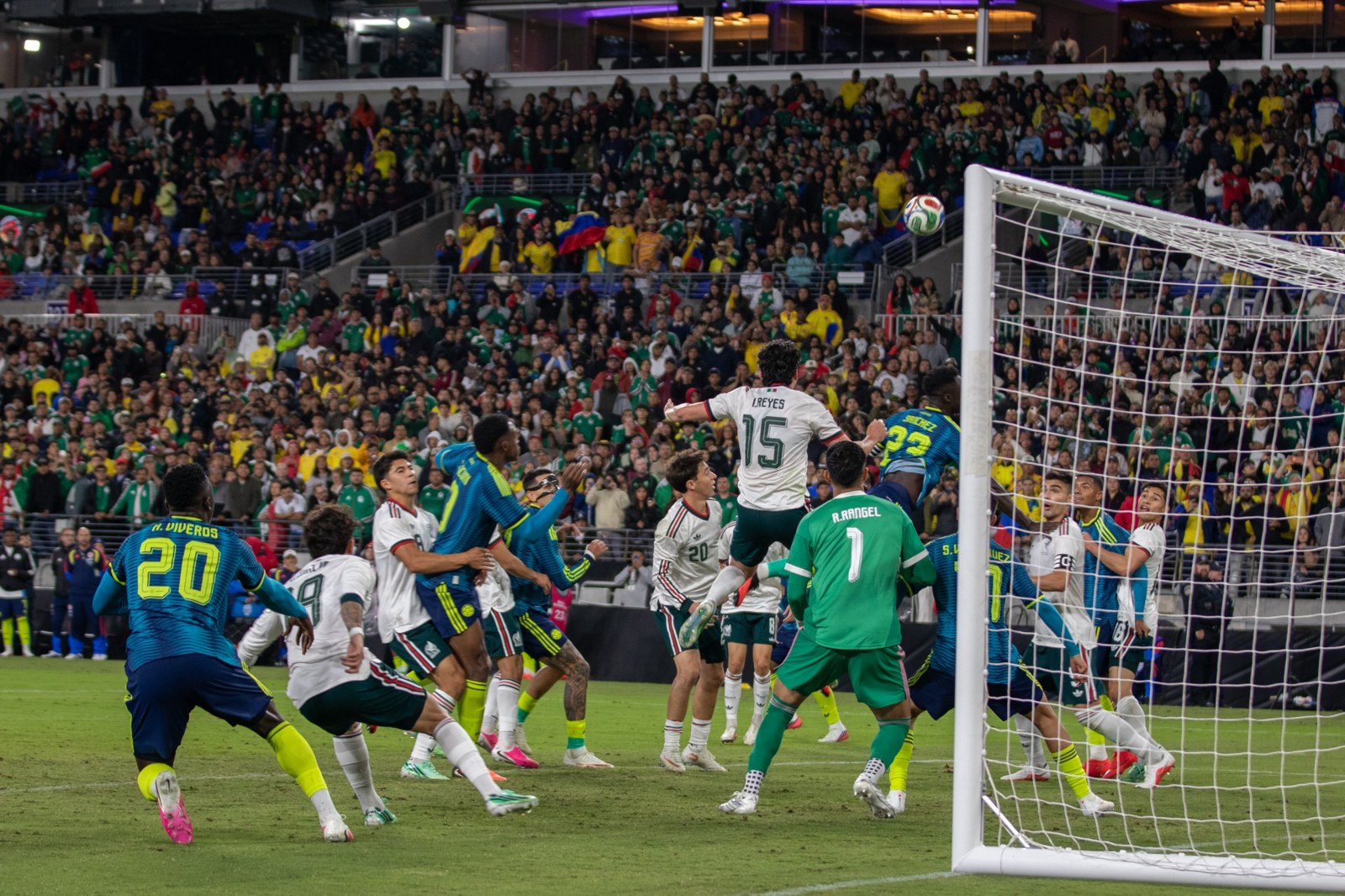 Players gather for an aerial ball in the goalmouth.